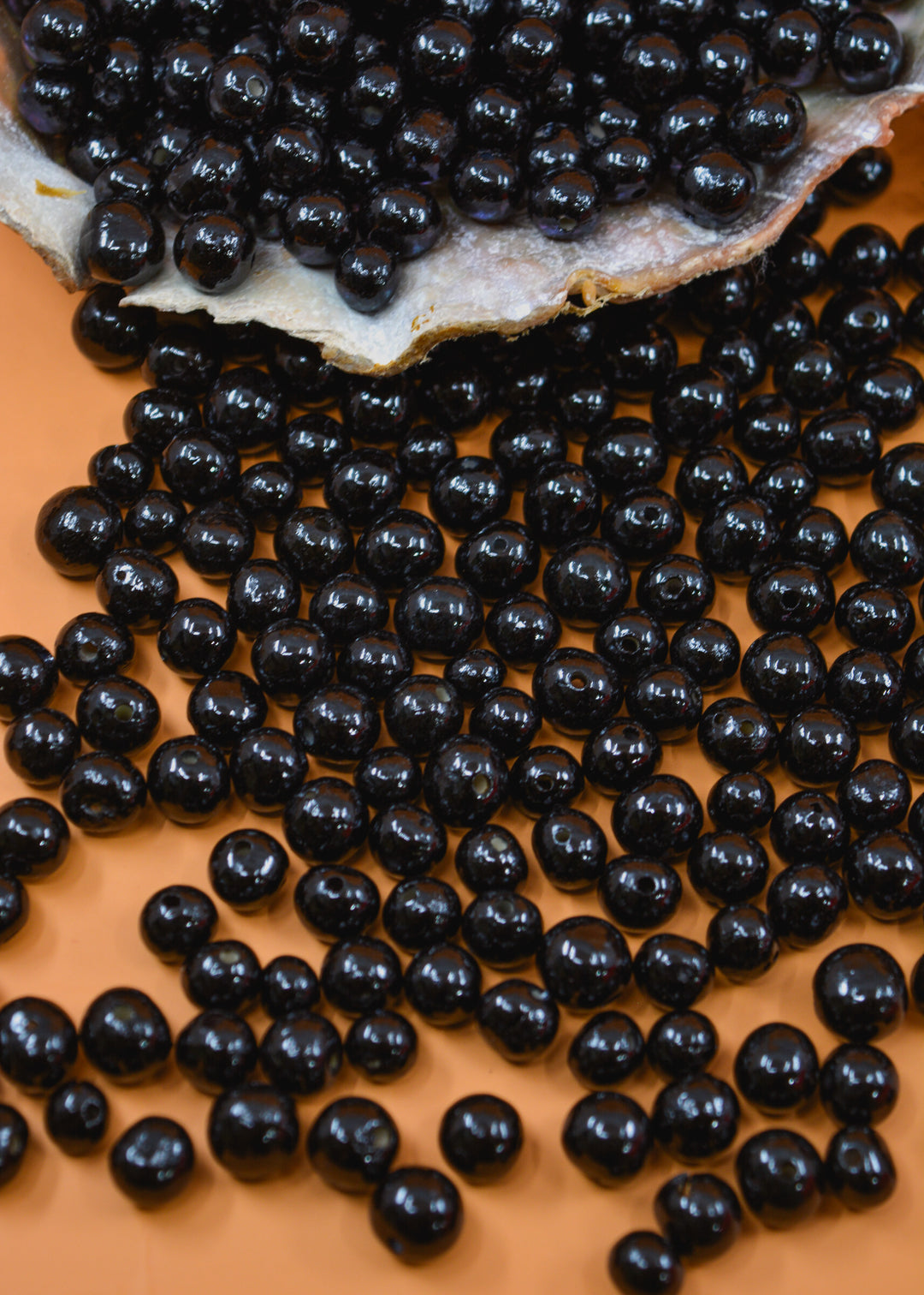 Varying sizes of Black acai beads being displayed for Jewelry makers.