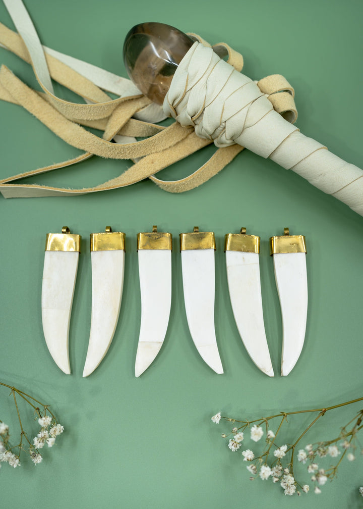 Cream white bone tusk pendant handmade in India from recycled cow bone featuring a polished gold-tone cap. Lightweight tribal-inspired focal pendant perfect for boho jewelry making, macrame necklaces, artisan designs, and statement jewelry.