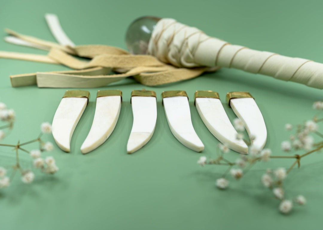 Cream white bone tusk pendant handmade in India from recycled cow bone featuring a polished gold-tone cap. Lightweight tribal-inspired focal pendant perfect for boho jewelry making, macrame necklaces, artisan designs, and statement jewelry.