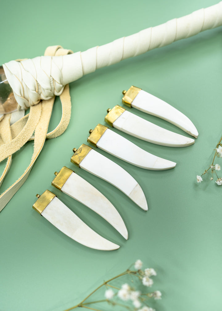 Cream white bone tusk pendant handmade in India from recycled cow bone featuring a polished gold-tone cap. Lightweight tribal-inspired focal pendant perfect for boho jewelry making, macrame necklaces, artisan designs, and statement jewelry.