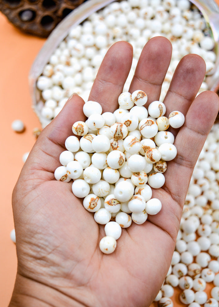 Bright White Acai Beads close up in the hands