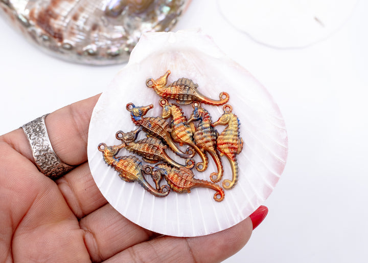 Tiny bronze and blue seahorse charm handmade from waterproof German resin. Lightweight ocean-inspired pendant perfect for beach jewelry, coastal accessories, earrings, charm necklaces, sweater pins, and mermaid-inspired designs.