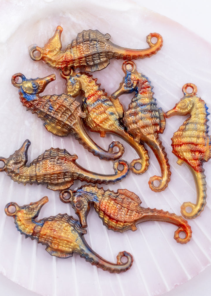 Tiny bronze and blue seahorse charm handmade from waterproof German resin. Lightweight ocean-inspired pendant perfect for beach jewelry, coastal accessories, earrings, charm necklaces, sweater pins, and mermaid-inspired designs.