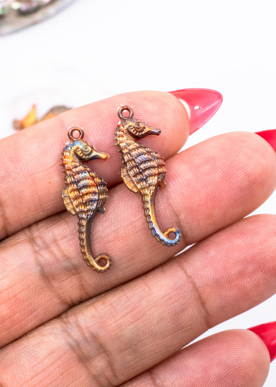 Tiny bronze and blue seahorse charm handmade from waterproof German resin. Lightweight ocean-inspired pendant perfect for beach jewelry, coastal accessories, earrings, charm necklaces, sweater pins, and mermaid-inspired designs.