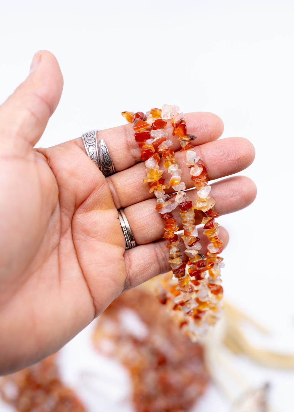Natural Carnelian chip beads featuring warm orange and red semi-precious gemstone chips on a 34 inch strand. Perfect for boho jewelry making, crystal-inspired designs, bracelets, necklaces, malas, earrings, and artisan gemstone creations.