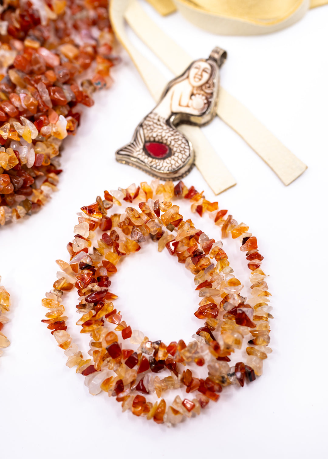Natural Carnelian chip beads featuring warm orange and red semi-precious gemstone chips on a 34 inch strand. Perfect for boho jewelry making, crystal-inspired designs, bracelets, necklaces, malas, earrings, and artisan gemstone creations.
