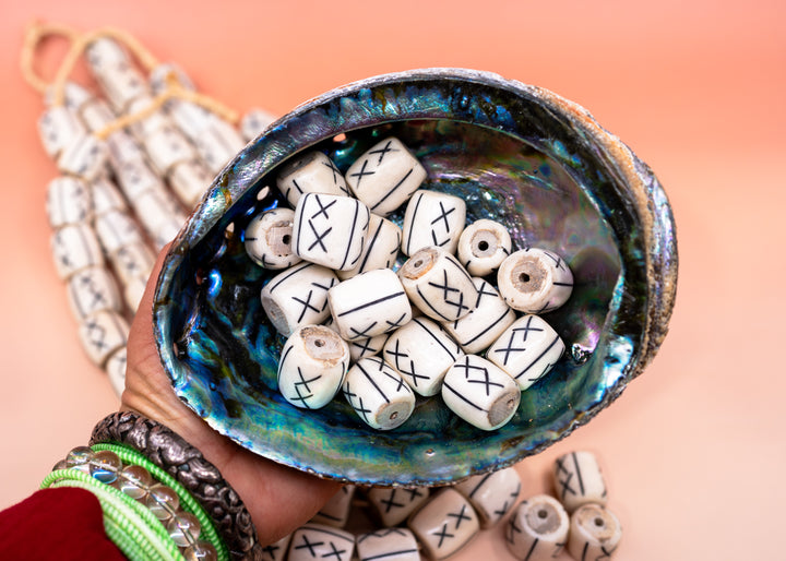 Hand-carved African bone beads handmade in Kenya from recycled cow bone featuring bold tribal X patterns and oversized barrel shapes. Perfect for boho jewelry making, statement necklaces, leather cord projects, macrame, braids, and artisan designs.