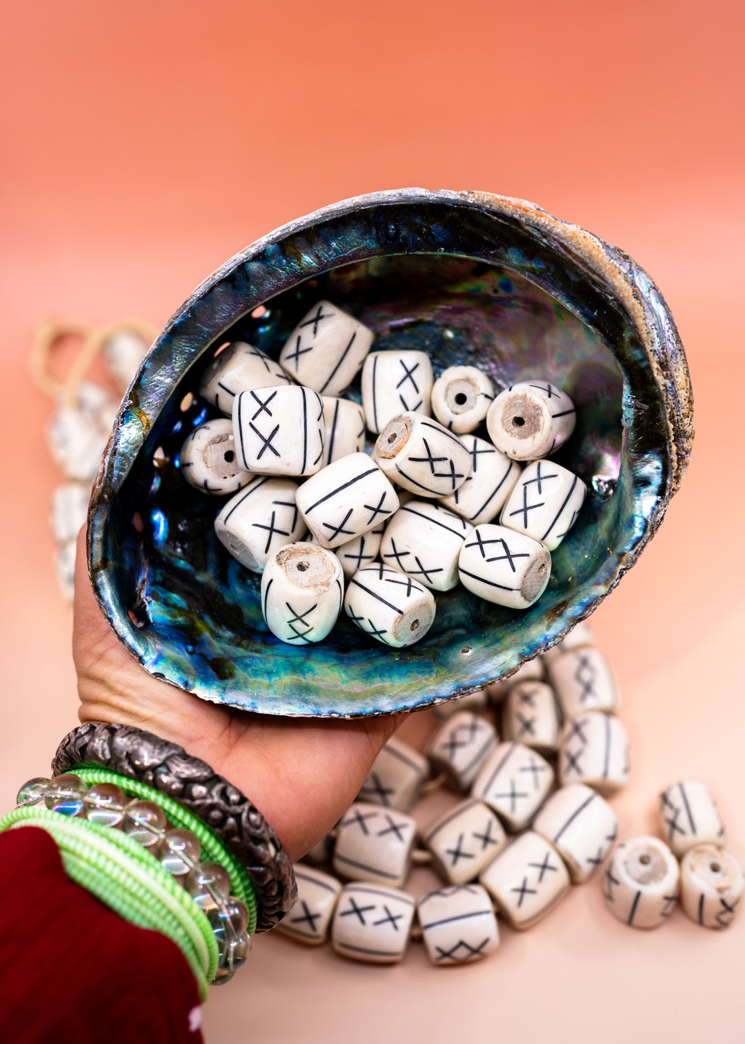 Hand-carved African bone beads handmade in Kenya from recycled cow bone featuring bold tribal X patterns and oversized barrel shapes. Perfect for boho jewelry making, statement necklaces, leather cord projects, macrame, braids, and artisan designs.
