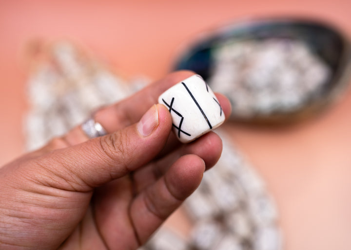 Hand-carved African bone beads handmade in Kenya from recycled cow bone featuring bold tribal X patterns and oversized barrel shapes. Perfect for boho jewelry making, statement necklaces, leather cord projects, macrame, braids, and artisan designs.