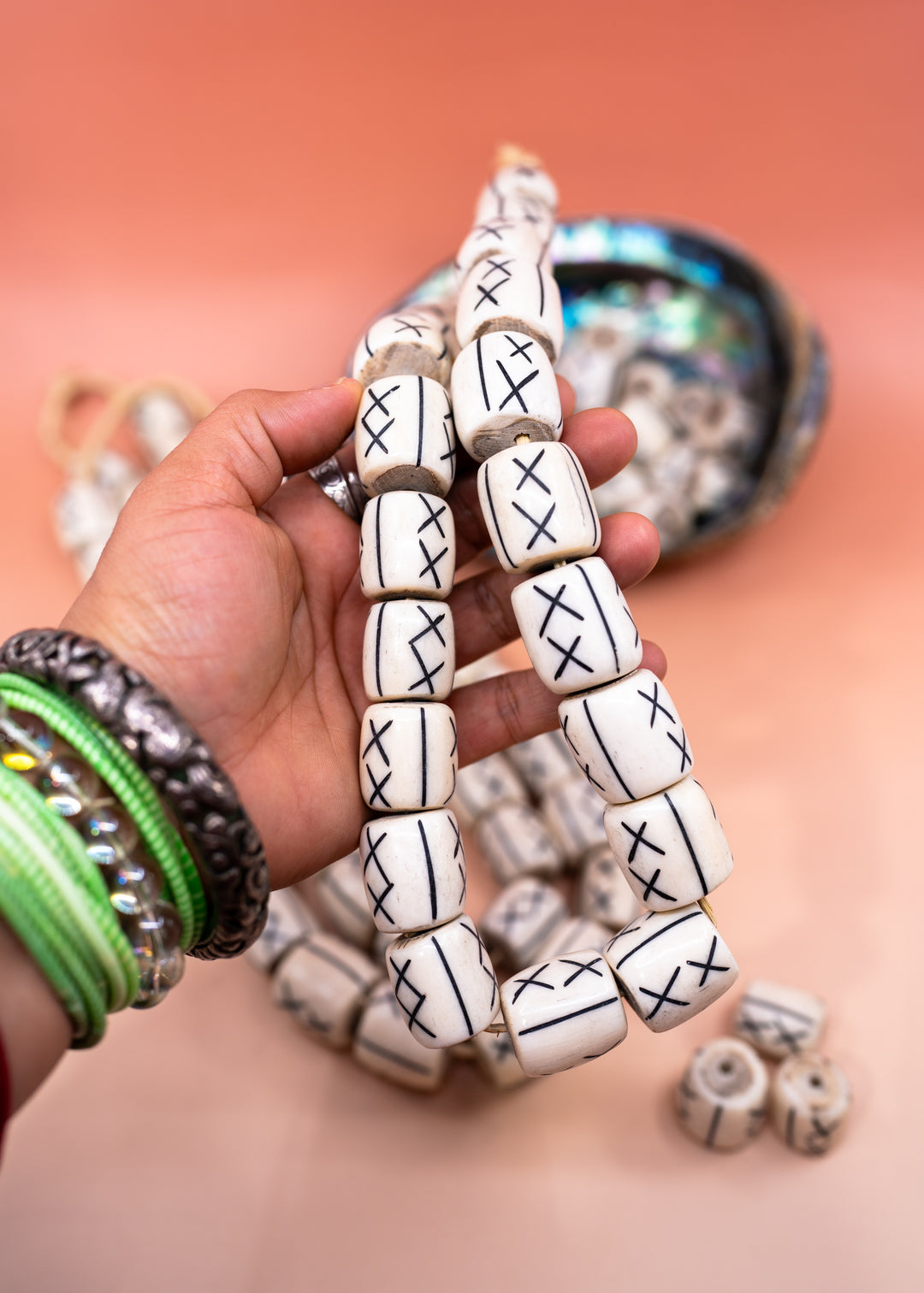 Hand-carved African bone beads handmade in Kenya from recycled cow bone featuring bold tribal X patterns and oversized barrel shapes. Perfect for boho jewelry making, statement necklaces, leather cord projects, macrame, braids, and artisan designs.