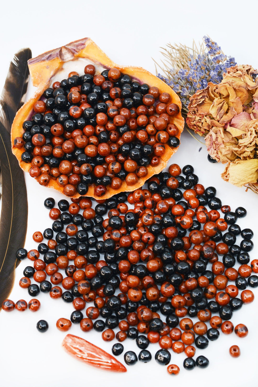 A collection of round acai beads, with a mix of red and black colors.