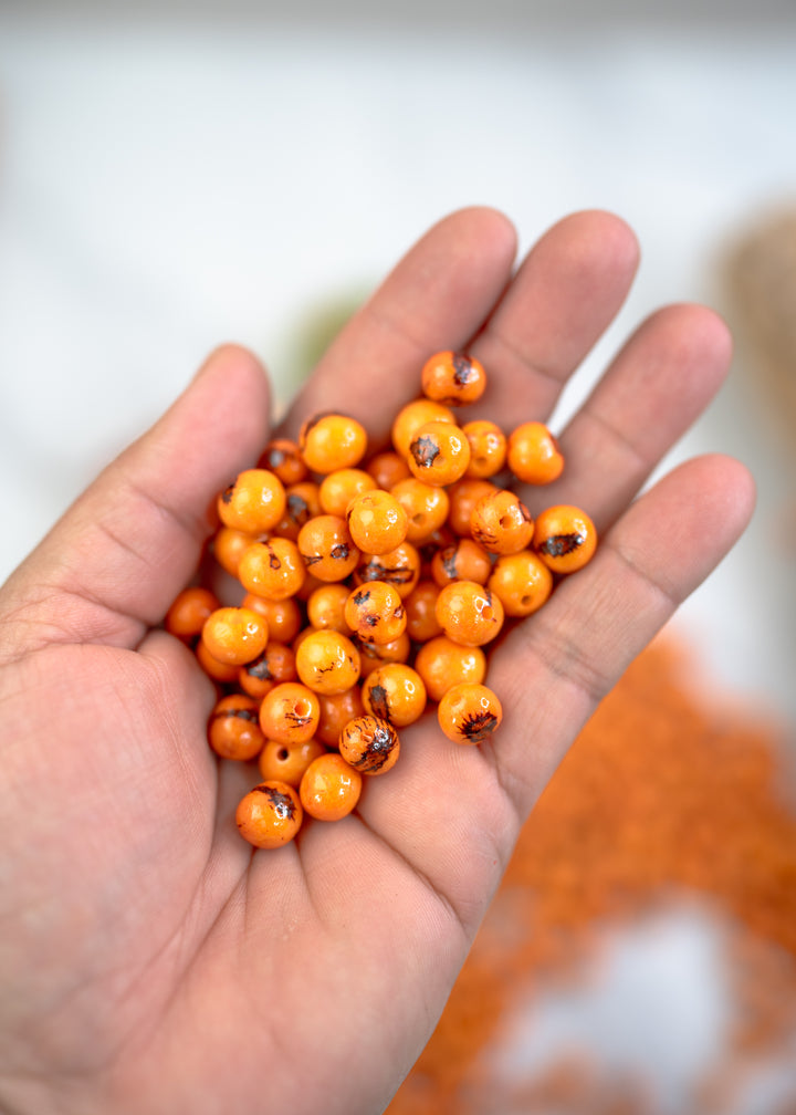 Natural Acai Beads in Orange for making bracelets.