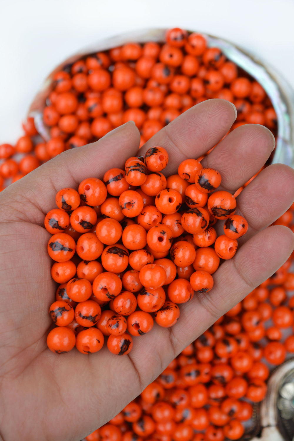 Fire orange acai seed beads close up natural texture