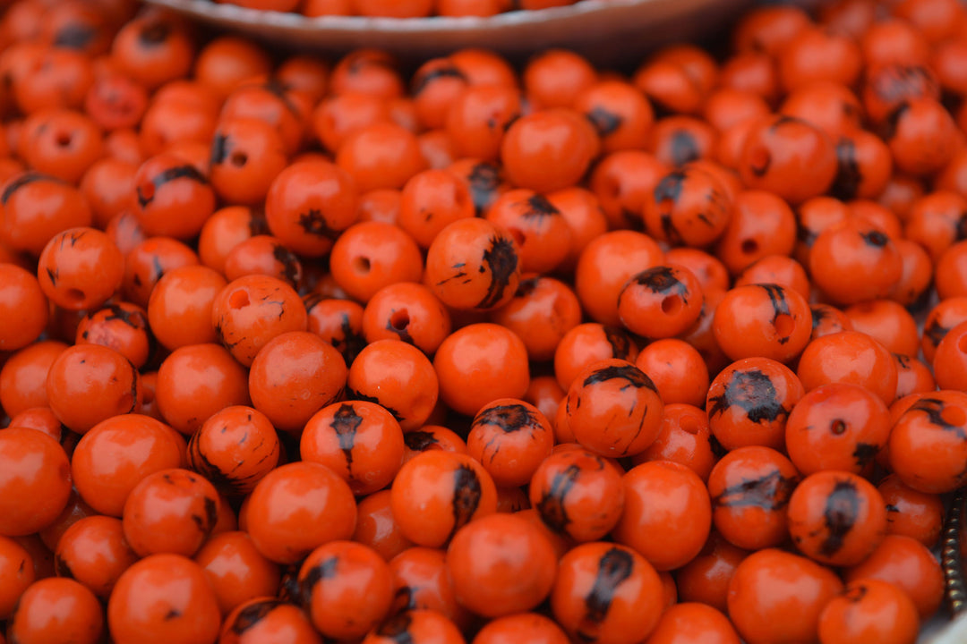Fire orange acai seed beads black markings