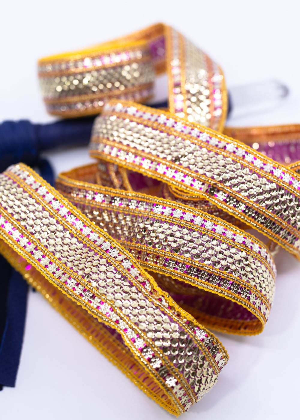 Gold sequin Indian trim with pink and yellow embroidered sari border detail. Decorative boho ribbon trim perfect for sewing, costumes, festival fashion, textile art, belly dance wear, handbags, pillows, and mixed media projects.
