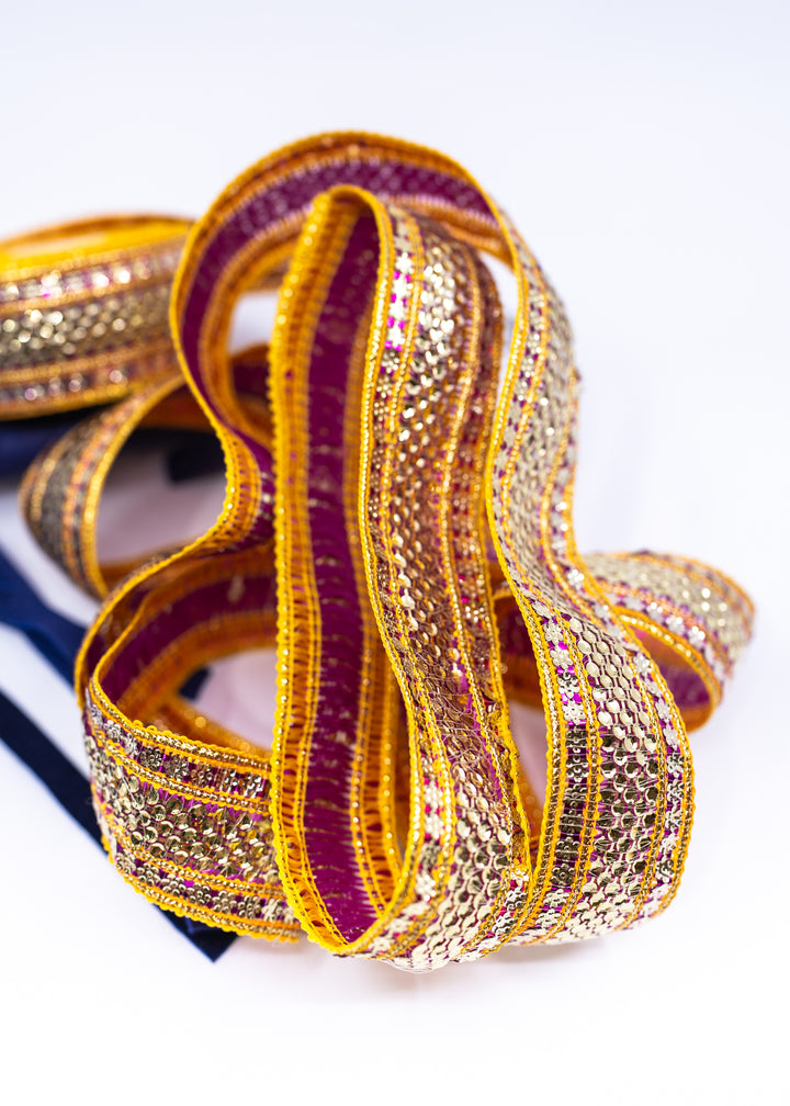 Gold sequin Indian trim with pink and yellow embroidered sari border detail. Decorative boho ribbon trim perfect for sewing, costumes, festival fashion, textile art, belly dance wear, handbags, pillows, and mixed media projects.