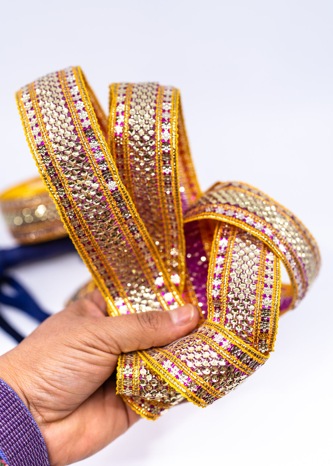 Gold sequin Indian trim with pink and yellow embroidered sari border detail. Decorative boho ribbon trim perfect for sewing, costumes, festival fashion, textile art, belly dance wear, handbags, pillows, and mixed media projects.