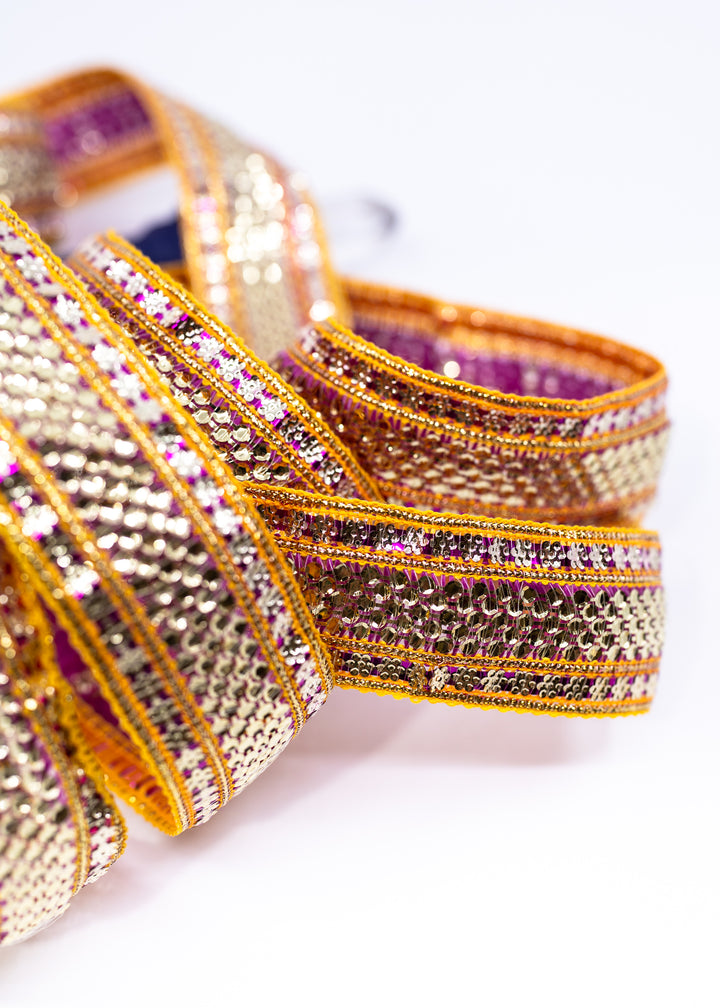Gold sequin Indian trim with pink and yellow embroidered sari border detail. Decorative boho ribbon trim perfect for sewing, costumes, festival fashion, textile art, belly dance wear, handbags, pillows, and mixed media projects.