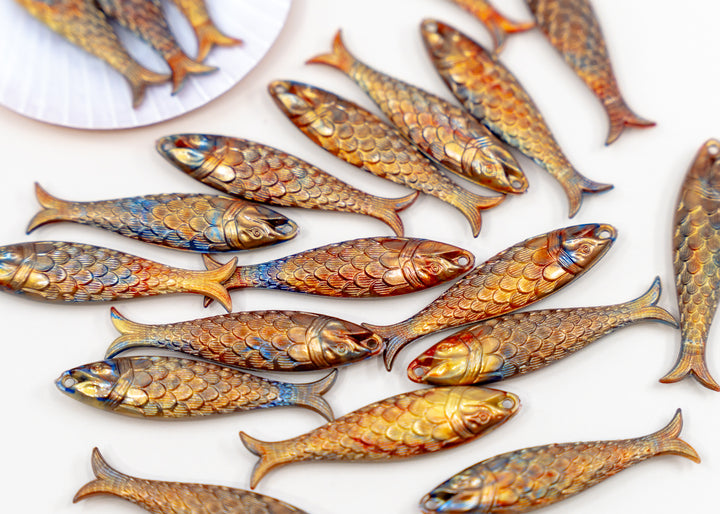 Golden Hour, Bronze German Resin Fish Charm featuring a realistic 48mm sardine pendant. Perfect for ocean charms, beach jewelry, fisherman aesthetic accessories, coastal jewelry, nautical designs, handmade earrings, necklaces, keychains, and artisan jewelry making.