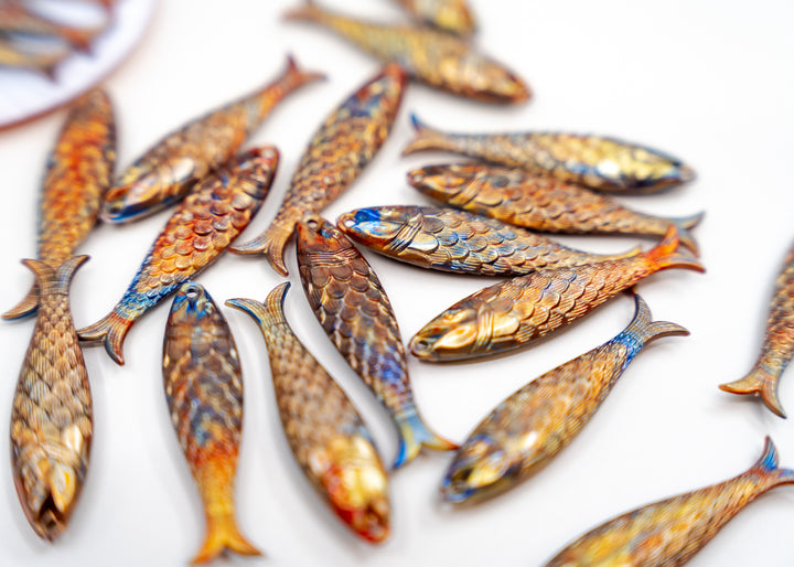 Golden Hour, Bronze German Resin Fish Charm featuring a realistic 48mm sardine pendant. Perfect for ocean charms, beach jewelry, fisherman aesthetic accessories, coastal jewelry, nautical designs, handmade earrings, necklaces, keychains, and artisan jewelry making.