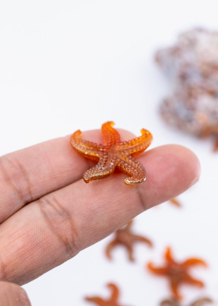 Golden Hour German resin starfish charm with warm amber and bronze marbling. Lightweight 30mm coastal pendant for beach jewelry, ocean-inspired crafts, and DIY jewelry making.