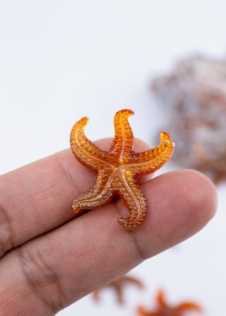 Golden Hour German resin starfish charm with warm amber and bronze marbling. Lightweight 30mm coastal pendant for beach jewelry, ocean-inspired crafts, and DIY jewelry making.
