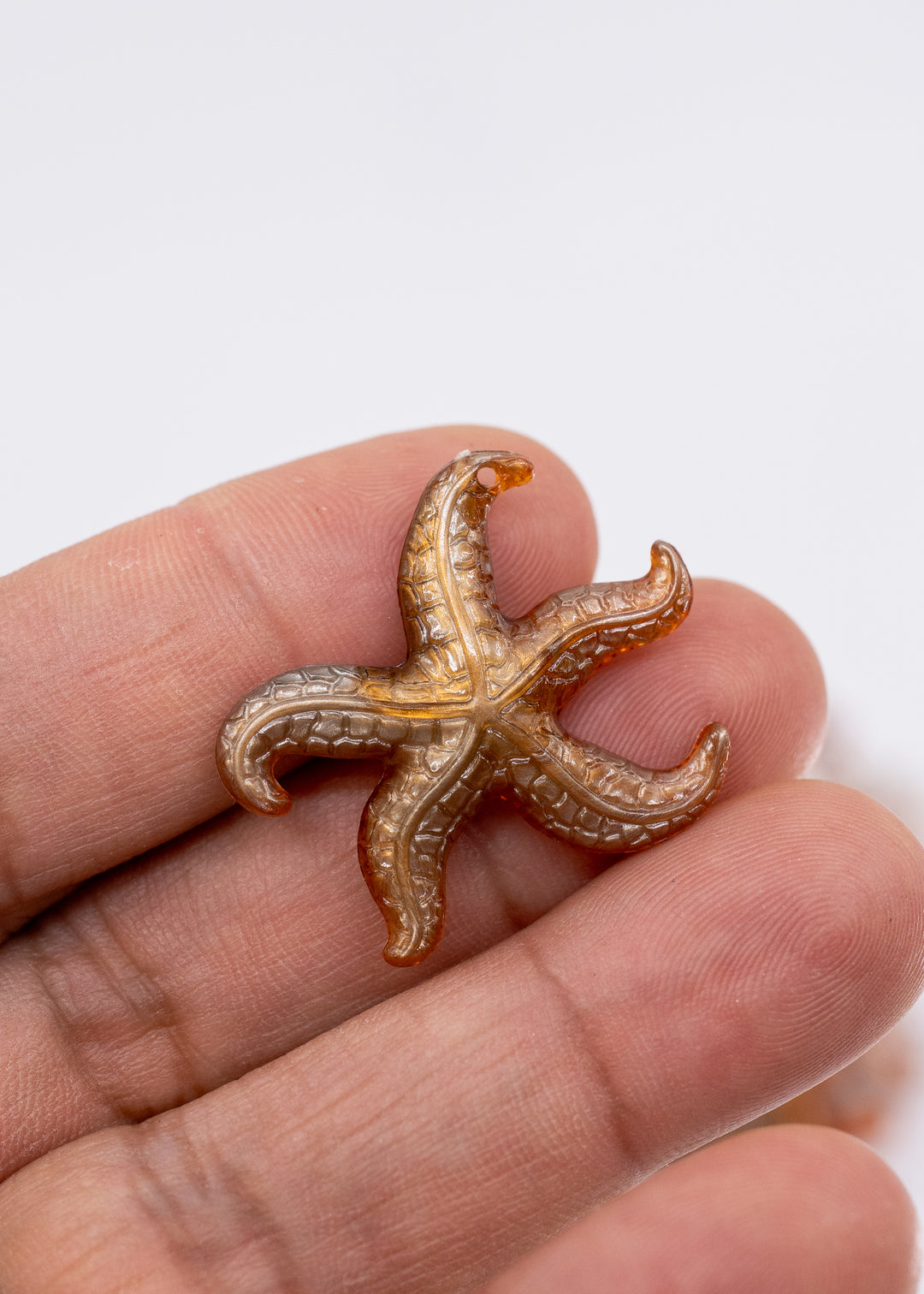 Golden Hour German resin starfish charm with warm amber and bronze marbling. Lightweight 30mm coastal pendant for beach jewelry, ocean-inspired crafts, and DIY jewelry making.