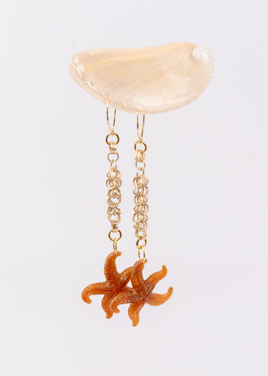 Golden Hour German resin starfish charm with warm amber and bronze marbling. Lightweight 30mm coastal pendant for beach jewelry, ocean-inspired crafts, and DIY jewelry making.