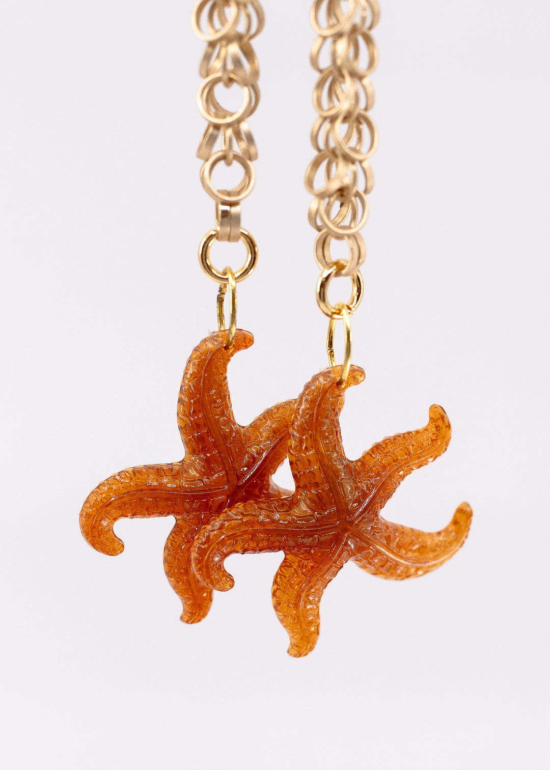 Golden Hour German resin starfish charm with warm amber and bronze marbling. Lightweight 30mm coastal pendant for beach jewelry, ocean-inspired crafts, and DIY jewelry making.