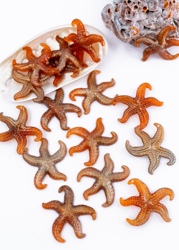 Golden Hour German resin starfish charm with warm amber and bronze marbling. Lightweight 30mm coastal pendant for beach jewelry, ocean-inspired crafts, and DIY jewelry making.