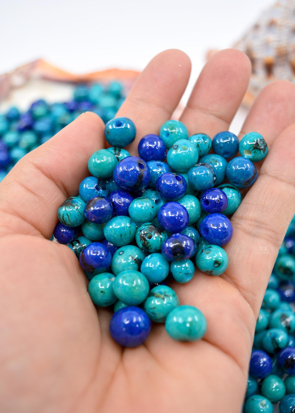 Acai Beads in Blue in the Hands.