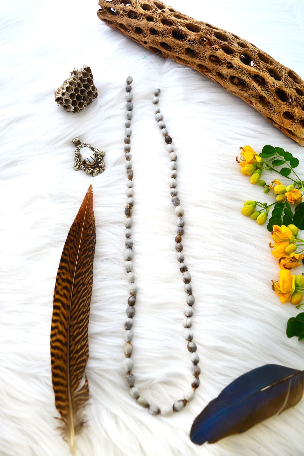 Natural Job’s Tears seed beads in earthy gray neutral tones featuring organic oval botanical beads for boho jewelry making, tribal necklaces, malas, meditation jewelry, mixed media art, and rustic artisan designs.