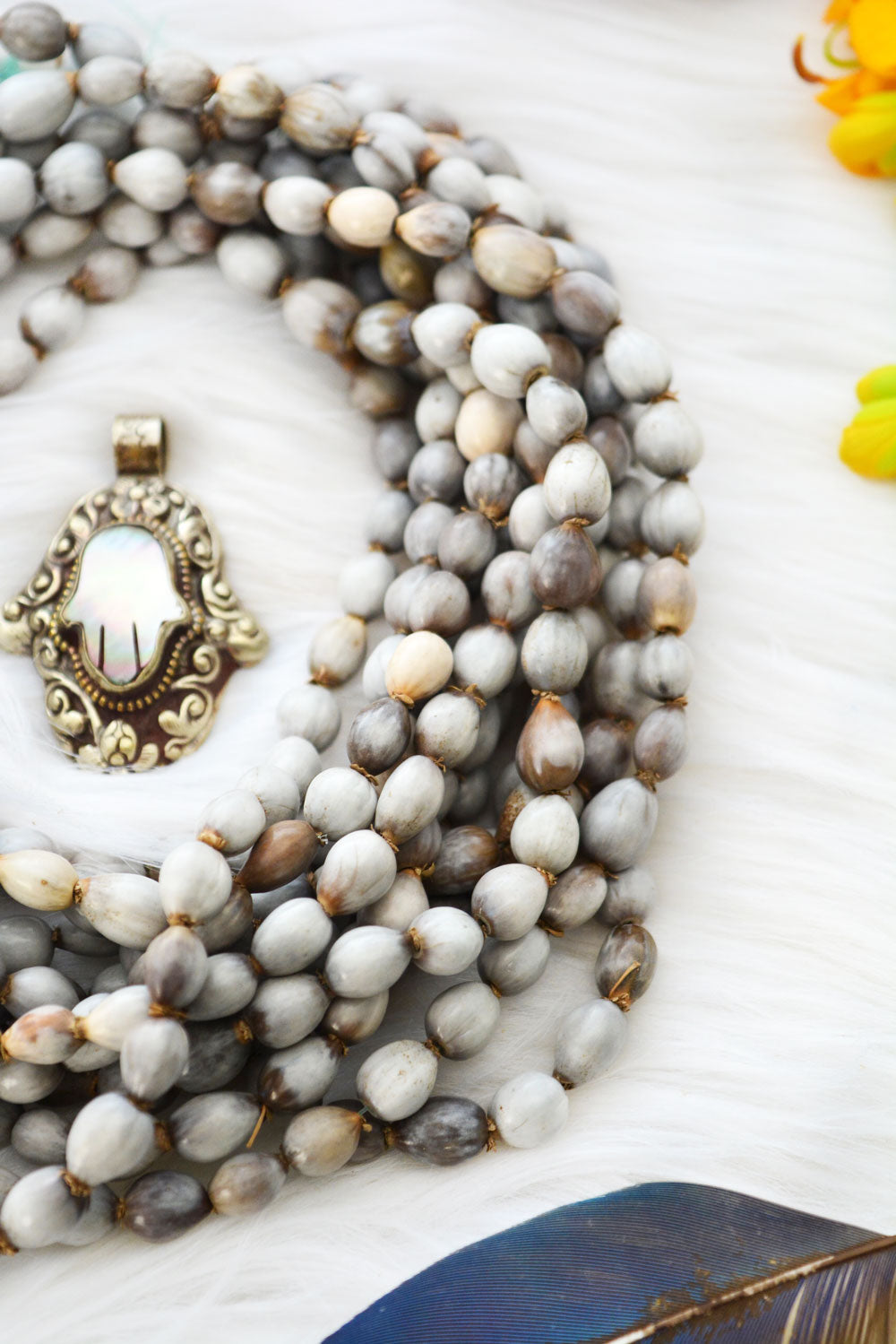 Natural Job’s Tears seed beads in earthy gray neutral tones featuring organic oval botanical beads for boho jewelry making, tribal necklaces, malas, meditation jewelry, mixed media art, and rustic artisan designs.