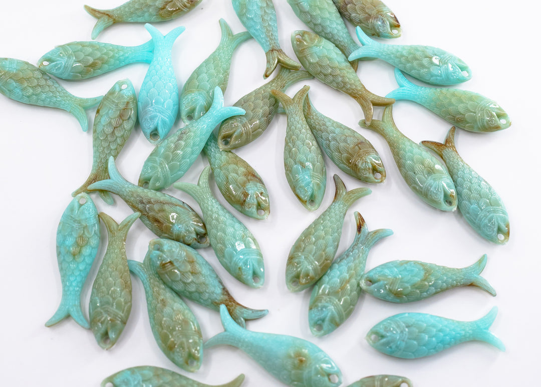 Marble Aqua blue fish charms handmade from glitter German resin featuring marbled sardine pendants perfect for ocean jewelry, mermaidcore accessories, beach fashion, coastal earrings, whimsical summer jewelry, and festival-inspired designs. These fish ocean charms are waterproof and perfect for beach jewelry.