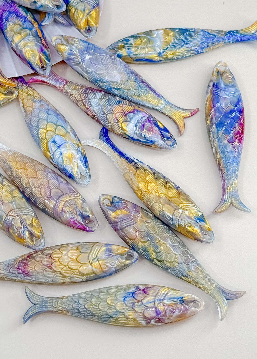 Marble Purple and Blue fish charms handmade from German resin featuring iridescent sardine pendants in coral and magenta tones. Perfect for ocean jewelry, mermaidcore accessories, coastal earrings, beach fashion, whimsical summer jewelry, and playful statement designs.