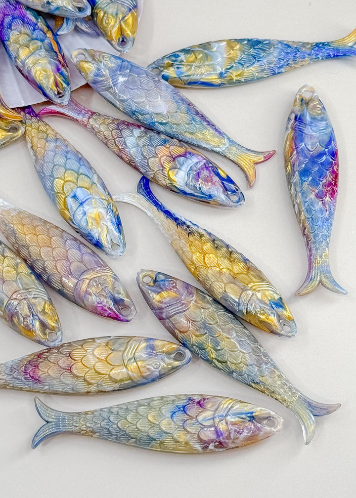 Marble Purple and Blue fish charms handmade from German resin featuring iridescent sardine pendants in coral and magenta tones. Perfect for ocean jewelry, mermaidcore accessories, coastal earrings, beach fashion, whimsical summer jewelry, and playful statement designs.