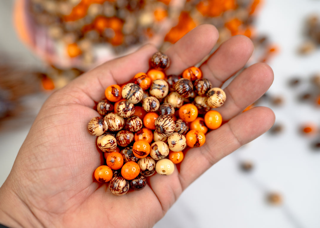 Close-up of Natural Brown and Cream and Orange Natural Acai Beads.