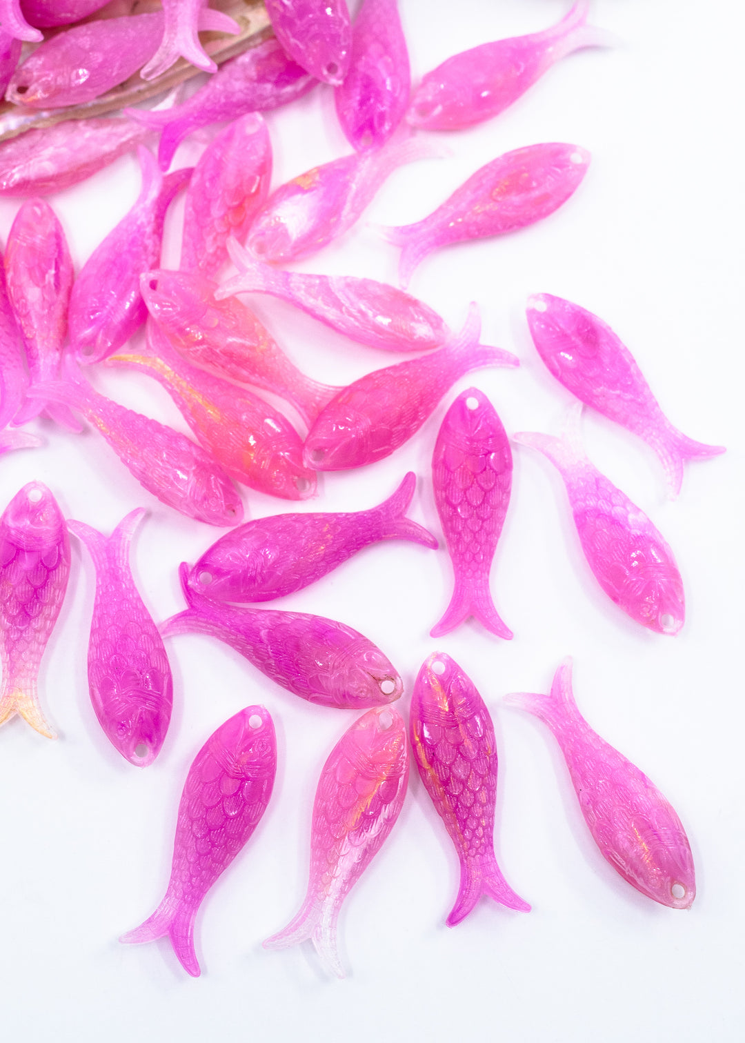 Mermaid candy pink fish charms handmade from glitter German resin featuring iridescent sardine pendants perfect for ocean jewelry, mermaidcore accessories, beach fashion, coastal earrings, whimsical summer jewelry, and festival-inspired designs. These fish ocean charms are waterproof and perfect for beach jewelry.