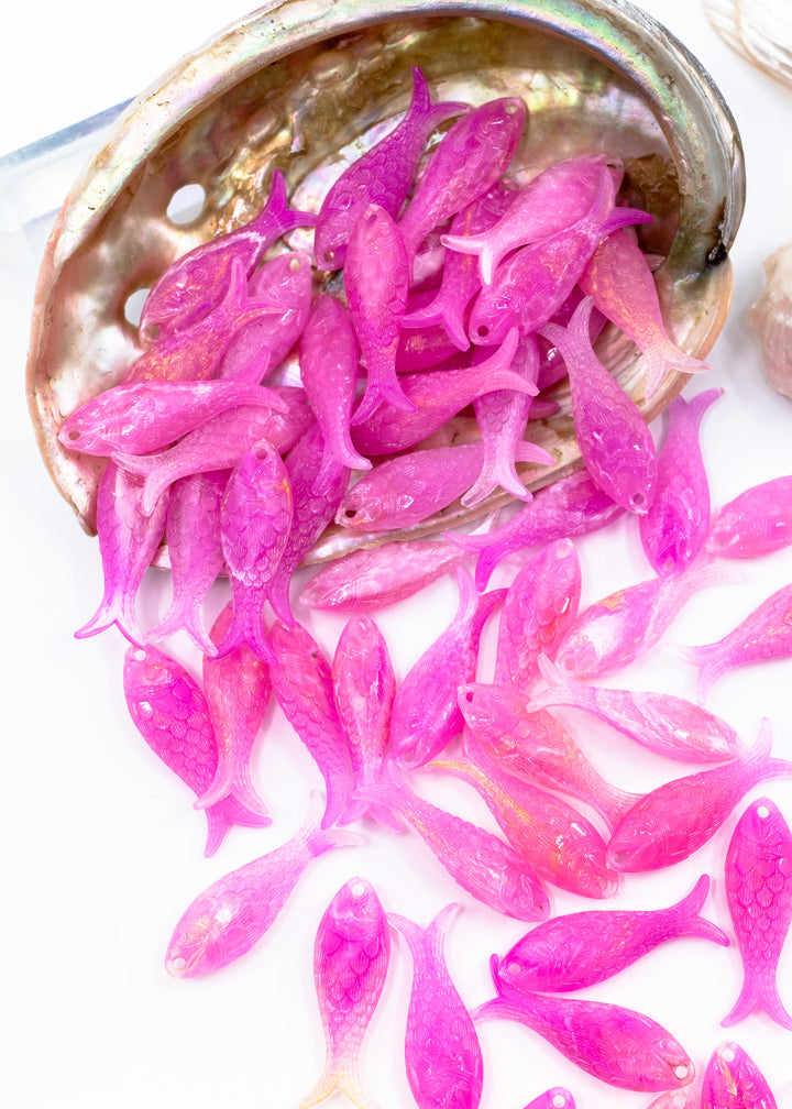 Mermaid candy pink fish charms handmade from glitter German resin featuring iridescent sardine pendants perfect for ocean jewelry, mermaidcore accessories, beach fashion, coastal earrings, whimsical summer jewelry, and festival-inspired designs. These fish ocean charms are waterproof and perfect for beach jewelry.