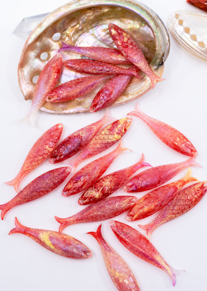 Pink mermaid glitter fish charms handmade from German resin featuring iridescent sardine pendants in coral and magenta tones. Perfect for ocean jewelry, mermaidcore accessories, coastal earrings, beach fashion, whimsical summer jewelry, and playful statement designs.
