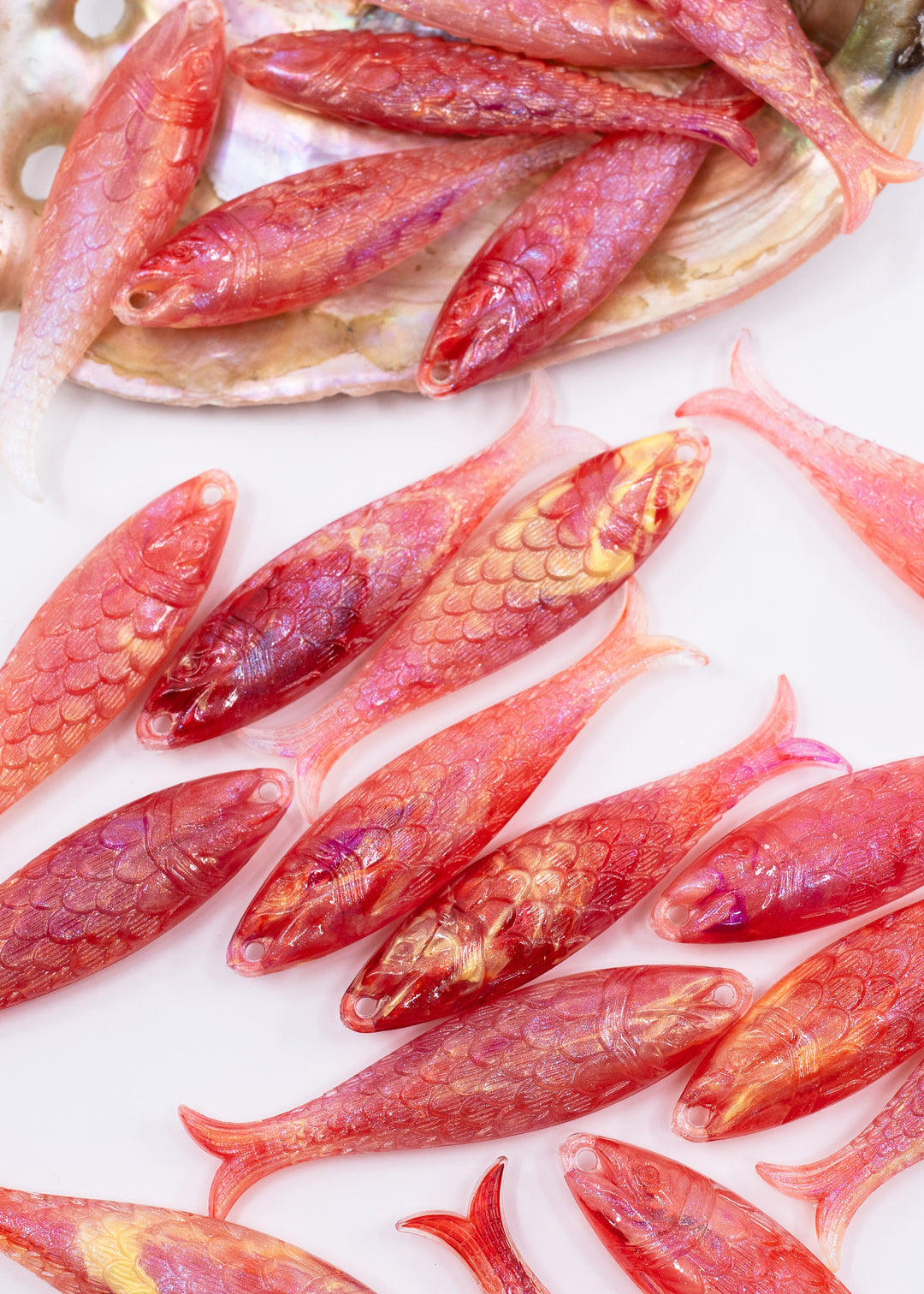 Pink mermaid glitter fish charms handmade from German resin featuring iridescent sardine pendants in coral and magenta tones. Perfect for ocean jewelry, mermaidcore accessories, coastal earrings, beach fashion, whimsical summer jewelry, and playful statement designs.
