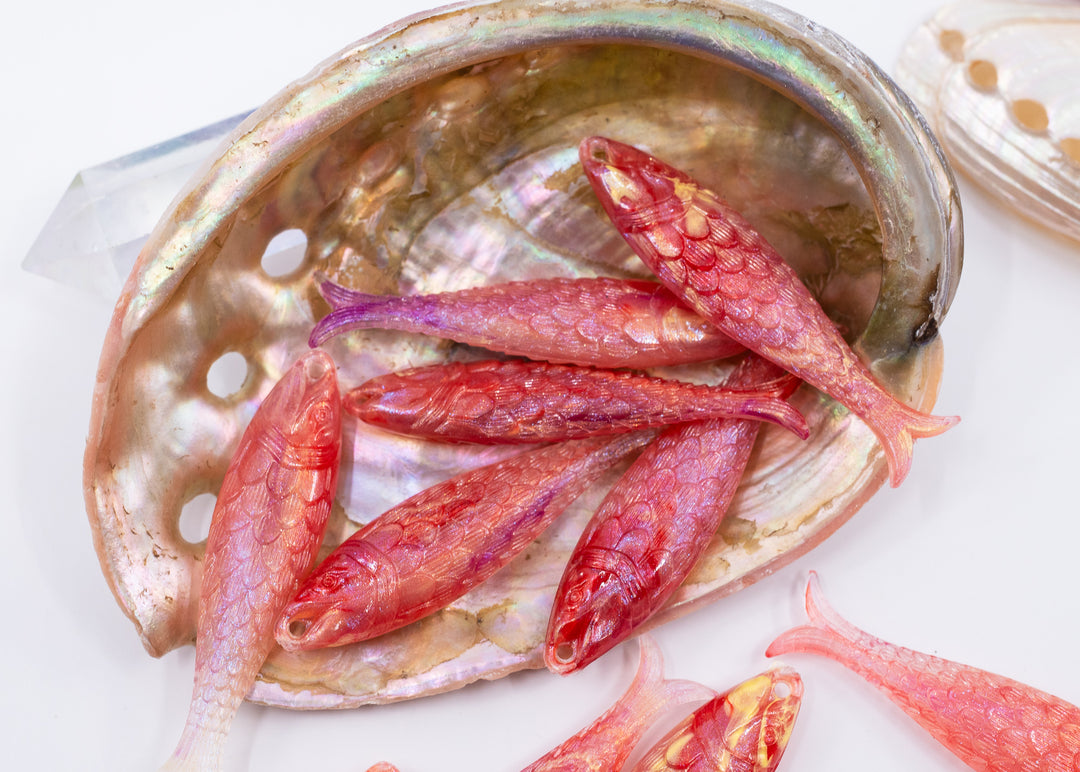 Pink mermaid glitter fish charms handmade from German resin featuring iridescent sardine pendants in coral and magenta tones. Perfect for ocean jewelry, mermaidcore accessories, coastal earrings, beach fashion, whimsical summer jewelry, and playful statement designs.