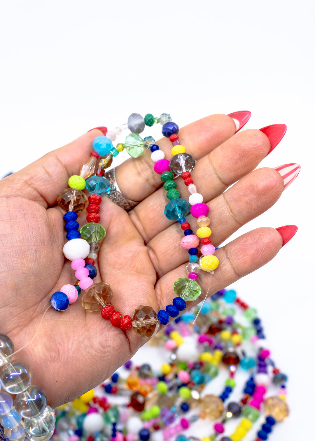 Assorted faceted acrylic beads in rainbow colors including pink, blue, yellow, green, and purple