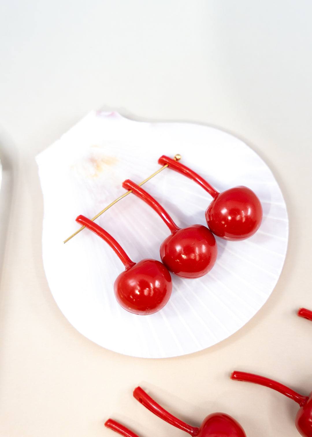Shop Red Cherry German resin beads, 31mm lightweight kitschy fruit beads for cherry earrings, statement jewelry and colorful DIY accessories.
