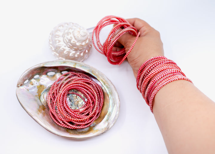 Red and white recycled flip flop bracelets handmade in Mali, West Africa featuring lightweight waterproof bangles perfect for boho arm stacks, beach jewelry, festival fashion, layered bracelets, artisan gifts, and colorful summer accessories.