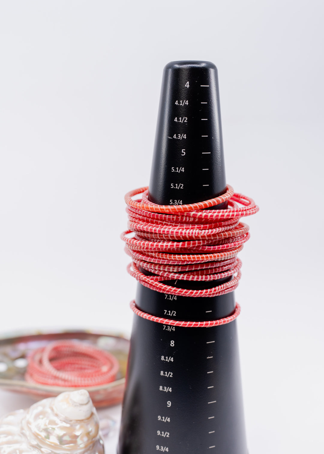 Red and white recycled flip flop bracelets handmade in Mali, West Africa featuring lightweight waterproof bangles perfect for boho arm stacks, beach jewelry, festival fashion, layered bracelets, artisan gifts, and colorful summer accessories.