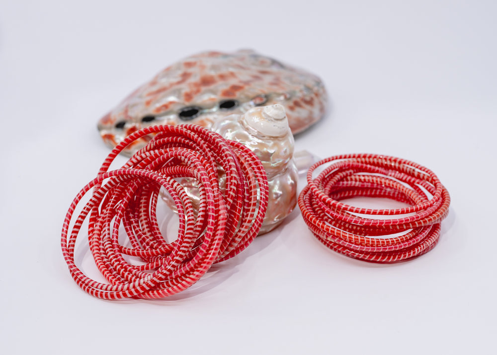 Red and white recycled flip flop bracelets handmade in Mali, West Africa featuring lightweight waterproof bangles perfect for boho arm stacks, beach jewelry, festival fashion, layered bracelets, artisan gifts, and colorful summer accessories.