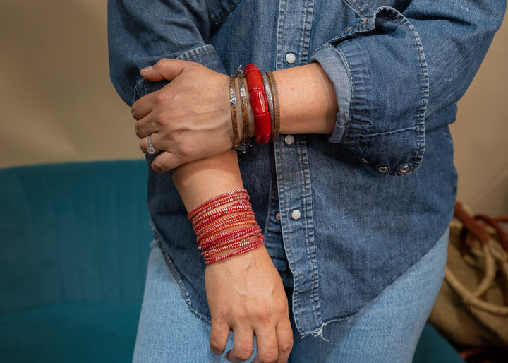 Red and white recycled flip flop bracelets handmade in Mali, West Africa featuring lightweight waterproof bangles perfect for boho arm stacks, beach jewelry, festival fashion, layered bracelets, artisan gifts, and colorful summer accessories.
