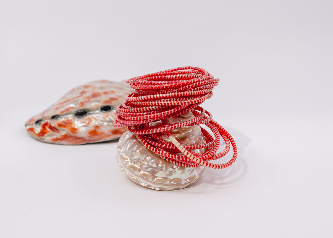 Red and white recycled flip flop bracelets handmade in Mali, West Africa featuring lightweight waterproof bangles perfect for boho arm stacks, beach jewelry, festival fashion, layered bracelets, artisan gifts, and colorful summer accessories.