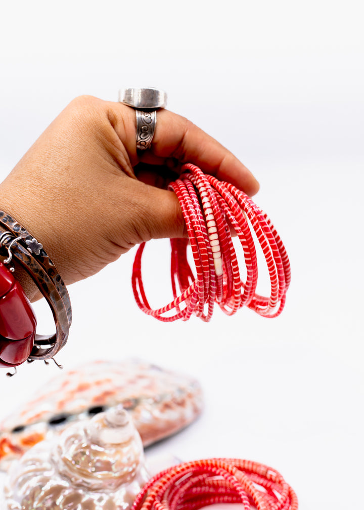 Red and white recycled flip flop bracelets handmade in Mali, West Africa featuring lightweight waterproof bangles perfect for boho arm stacks, beach jewelry, festival fashion, layered bracelets, artisan gifts, and colorful summer accessories.